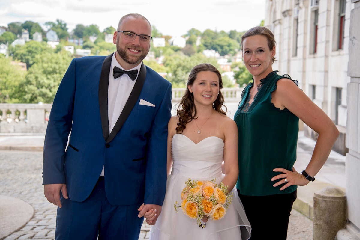 RI Wedding Photographer standing with the bride and groom in front of the State House