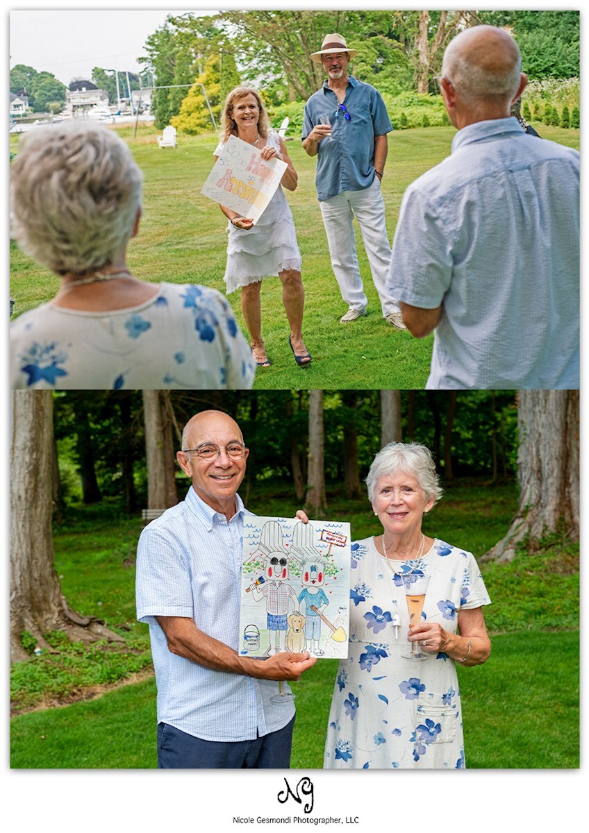 husband and wife holding handmade anniversary card