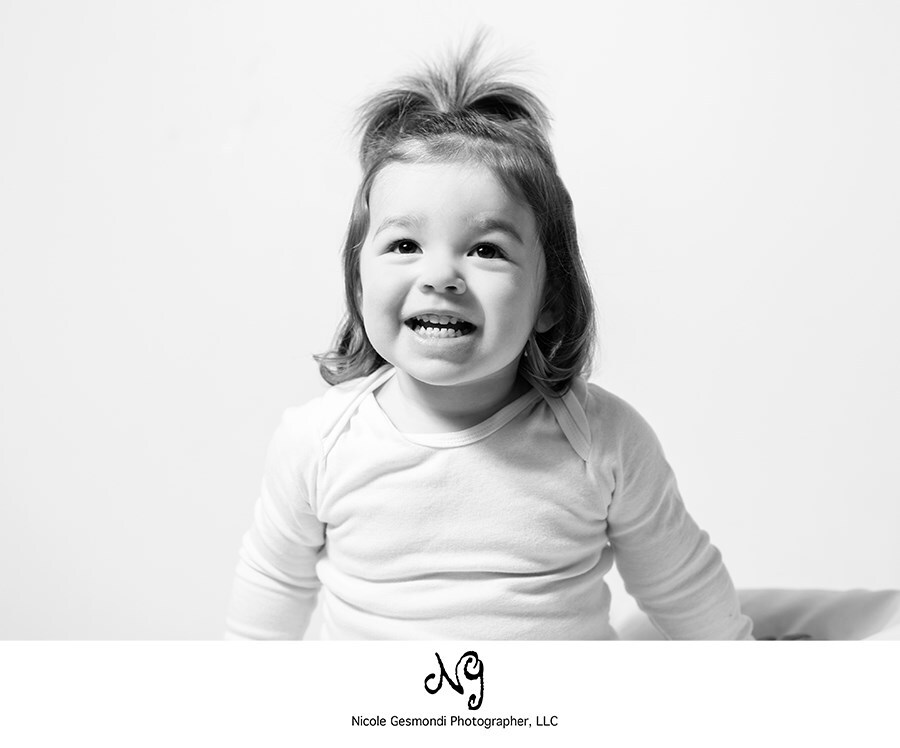 smiley toddler girl black and white photo