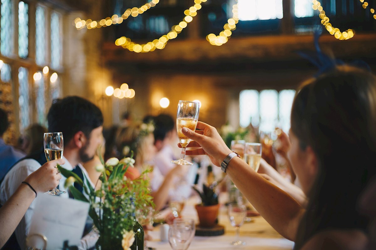 detail photo of a wedding champagne toast. Photo by Al Elmes from Splash