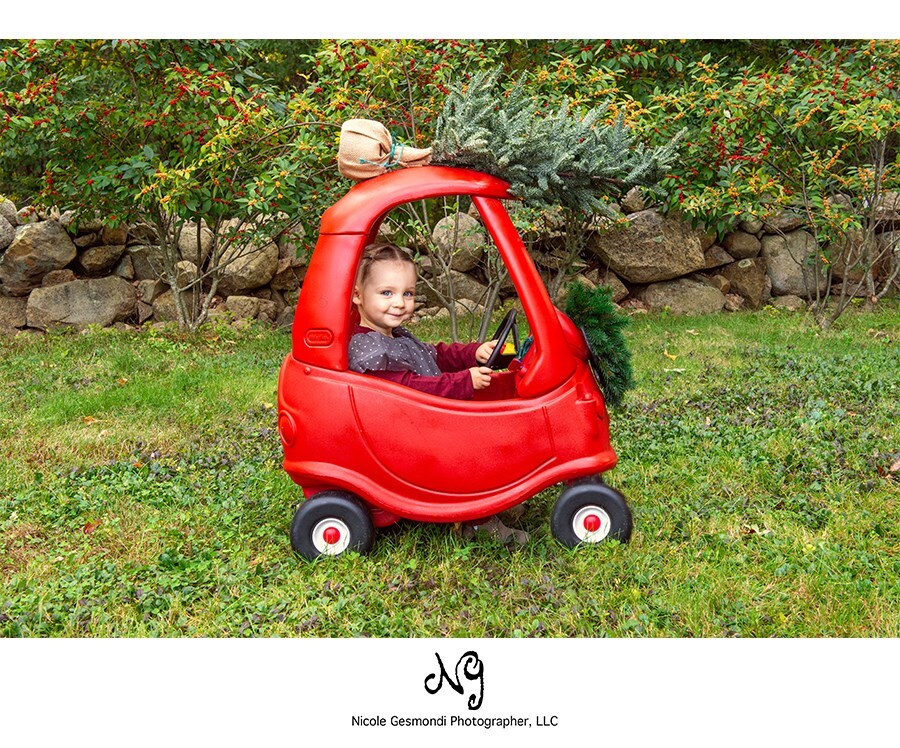little tikes cozy coupe with christmas tree and toddler girl