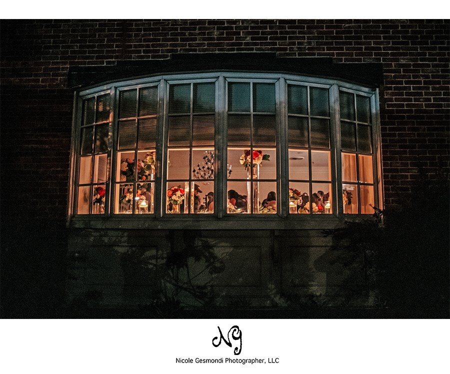 Outside looking in wedding reception at Wannamoisett Country Club